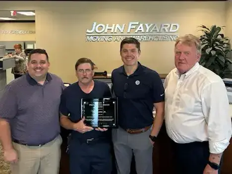 Lee Gore is recognized with a plaque for his years of safe driving as a local driver